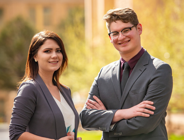 Two leadership minor students pose for a photo in suits