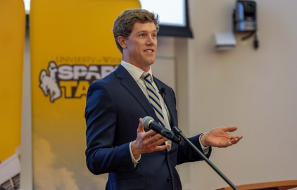 Leadership minor student speaks at a microphone