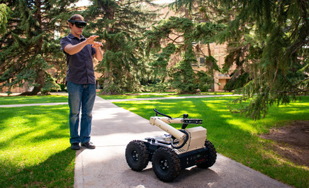 A student controls a robot