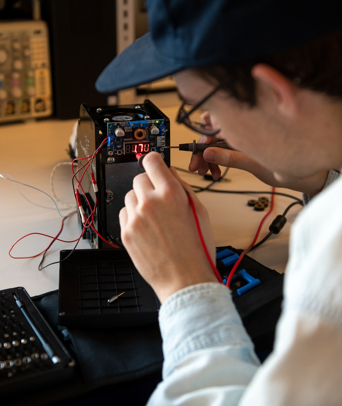A student works on a piece of equipment