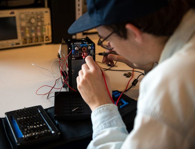 A student works on a piece of equipment