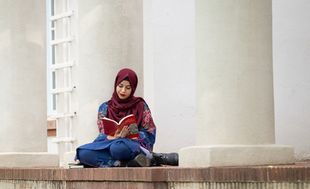 Student reading on campus
