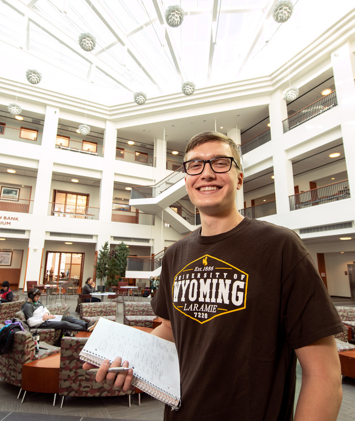 Management student in the College of Business atrium 