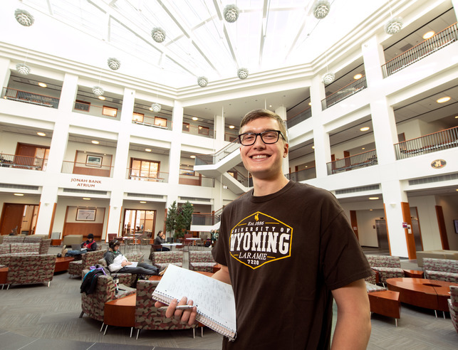 Management student in the College of Business atrium 