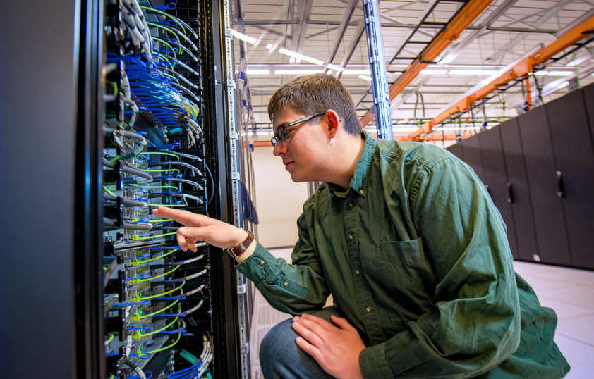 A person works on a super computer