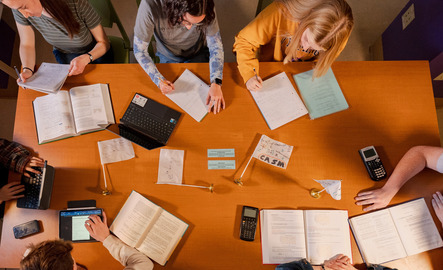 A group of students and math tutors do homework together