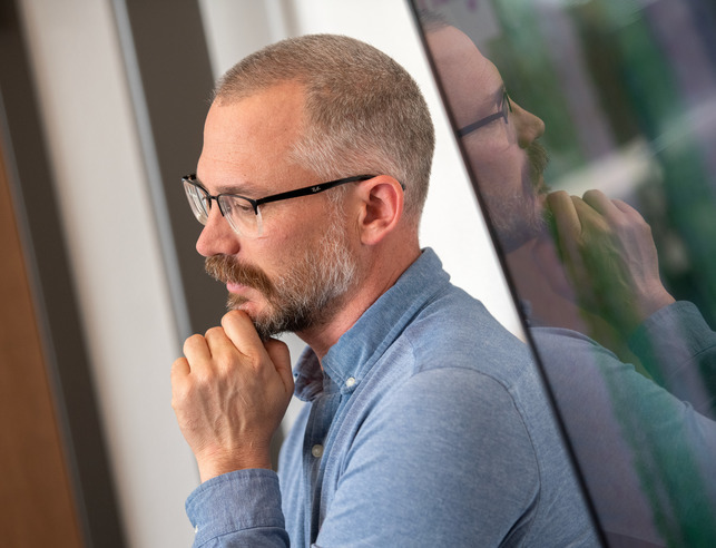 Mathematics graduate student works on a dry erase board