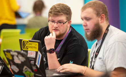 Two math students work on a computer