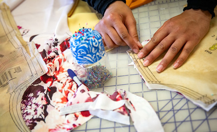 A close up shot of a student sewing