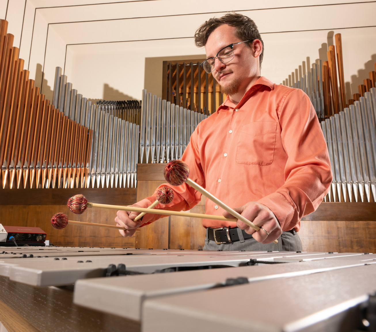 A student plays the xylophone