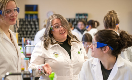 Molecular biology professor talks to two students