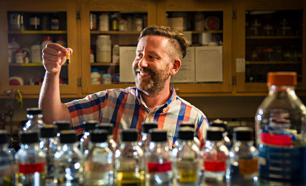 Molecular biology professor holds up a vial