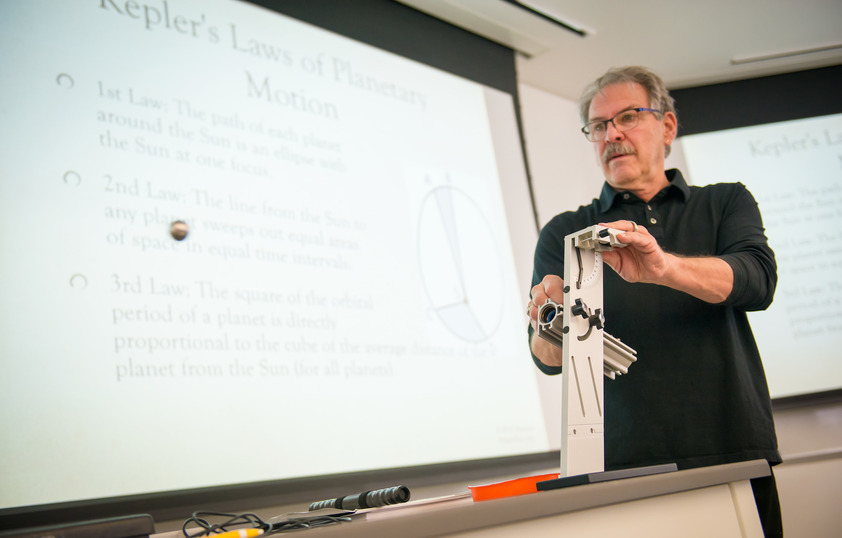 Science professor presenting to class with an experiement
