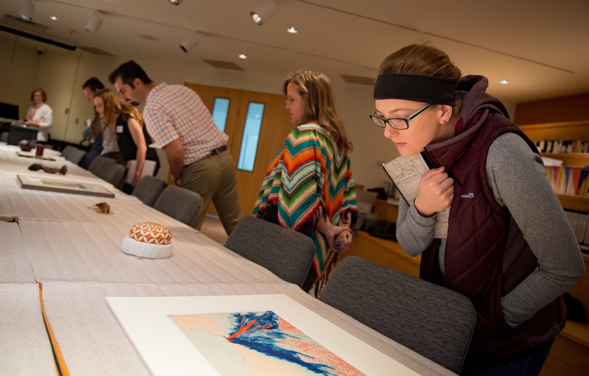 Students examining art in class