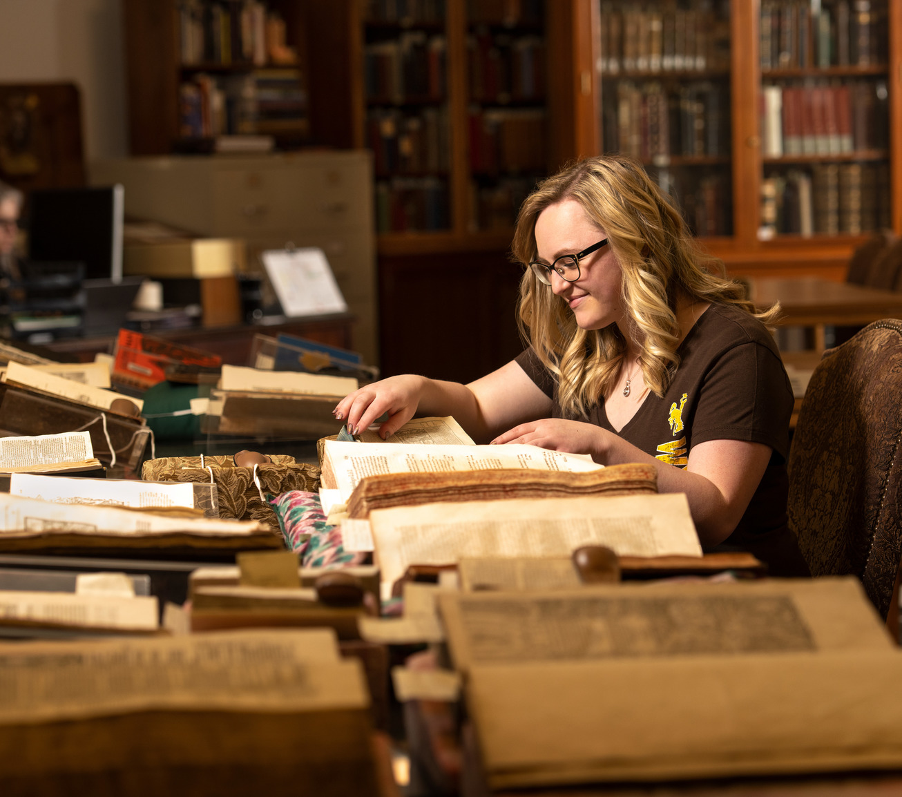 Student looking at old books in a museum