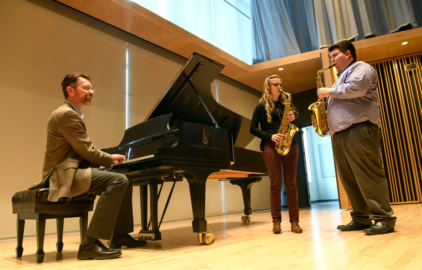 Professor playing instruments with students