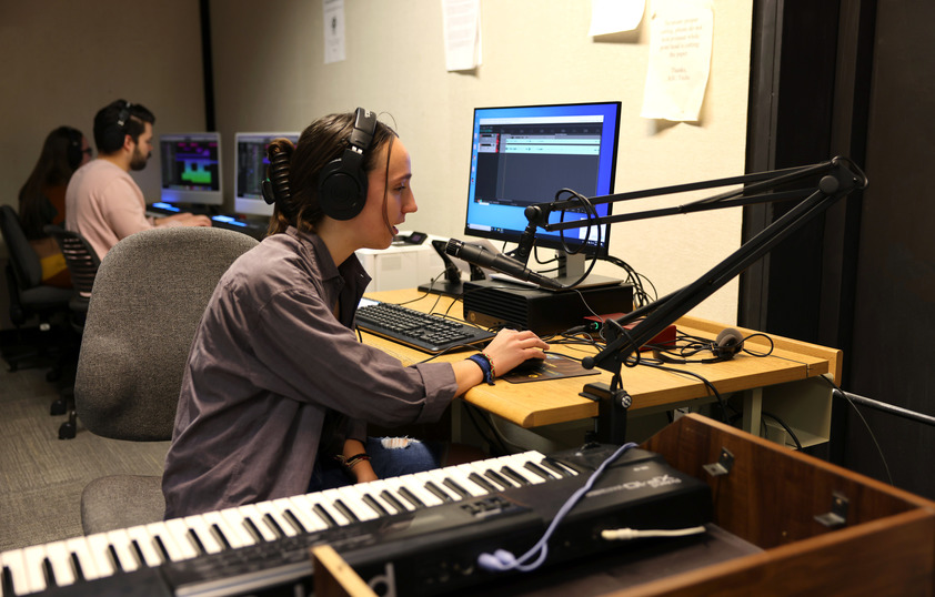 A student in an audio studio