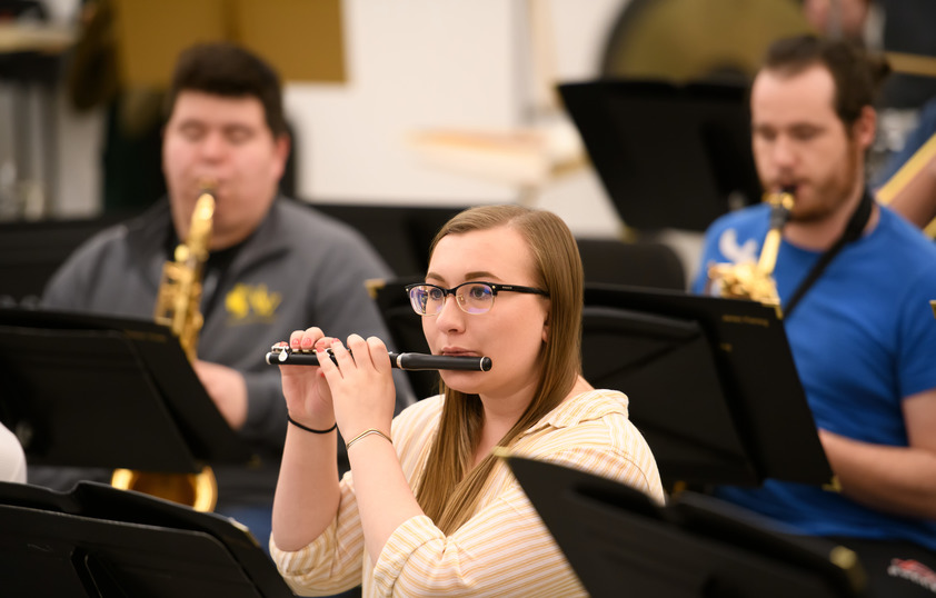 3 students playing musical instruments