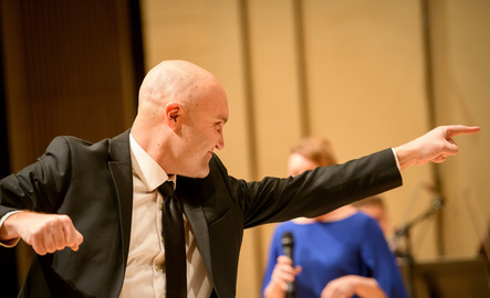 Faculty member conducting a musical performance