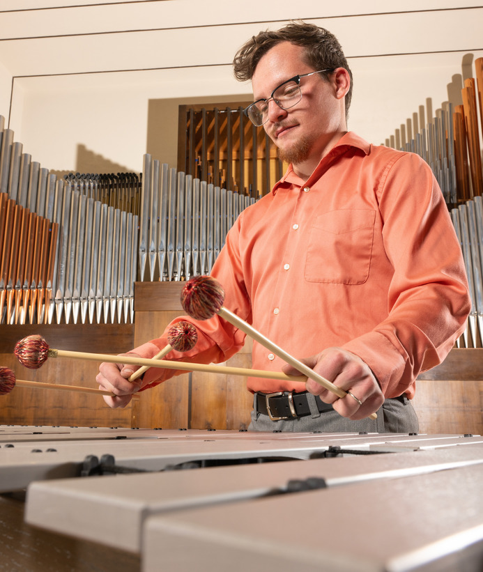 A student plays the xylophone during a music performance