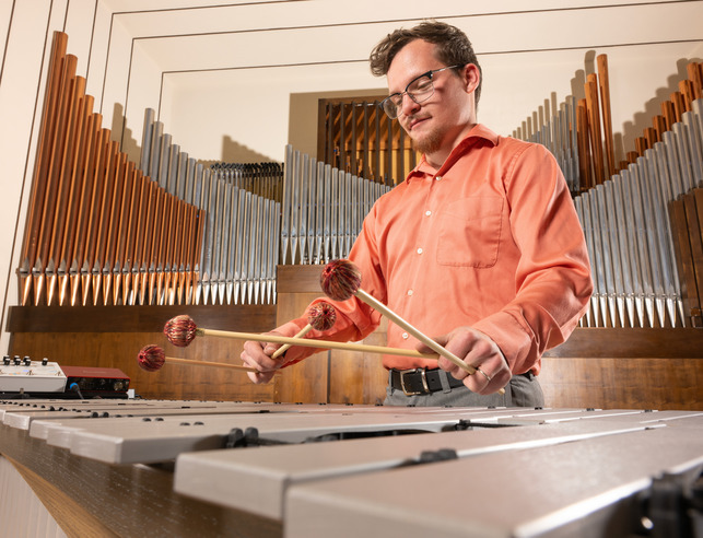 A student plays the xylophone during a music performance