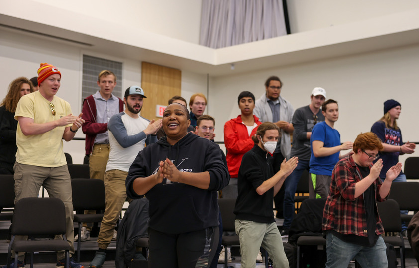 Students clap, dance and sing during a class