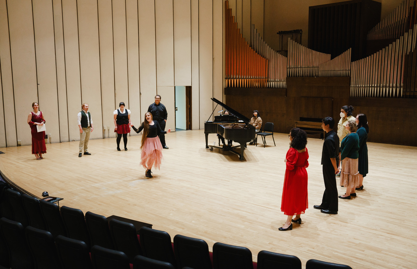 Student actors performing a scene on stage during practice