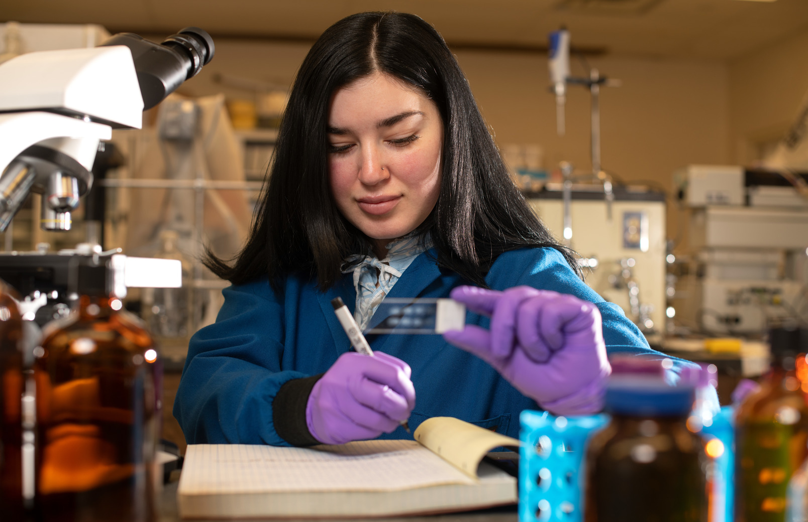 Student in lab looking at lab slide