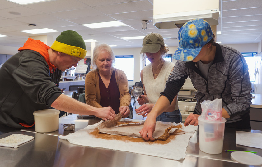 Students working with teaching in lab to make swiss roll