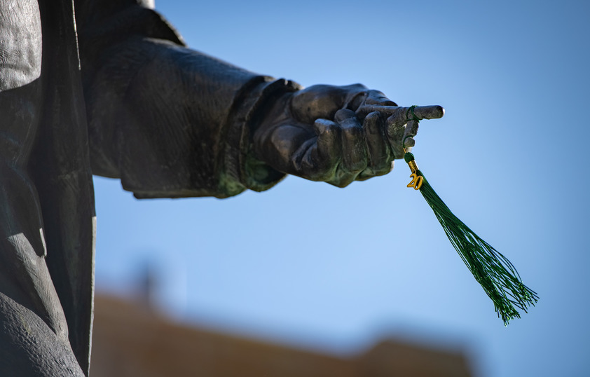 Ben Franklin statue holding graduation tassle