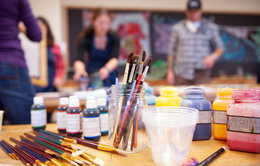 Paint brushes and paints on a table