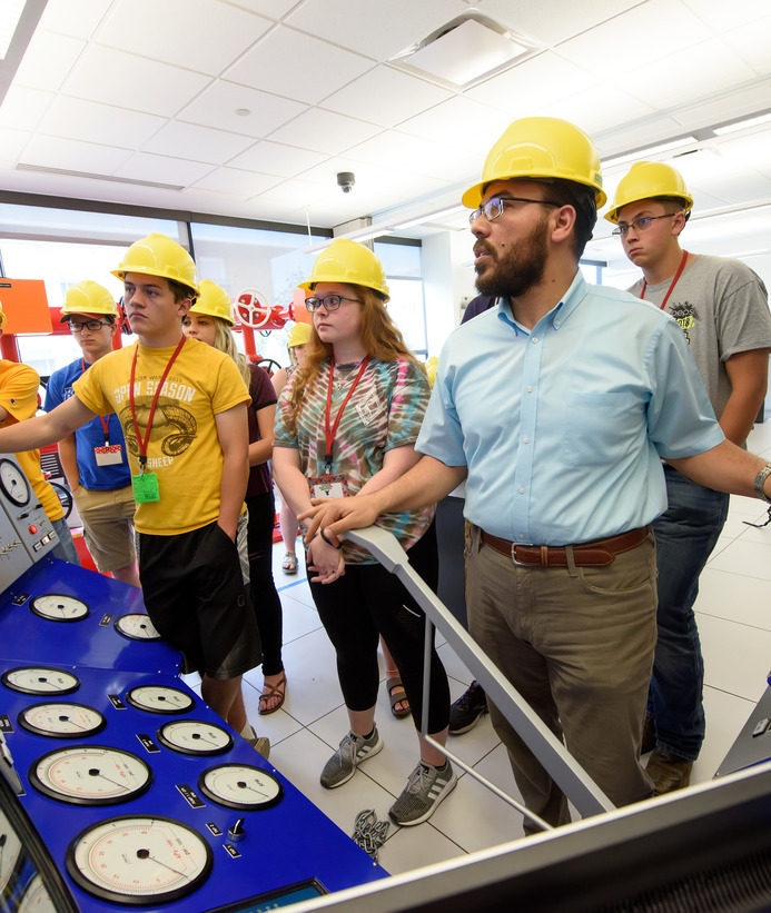 Petroleum engineering professor teaching students in a lab