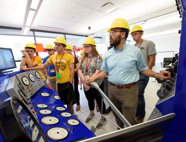 Petroleum engineering professor teaching students in a lab