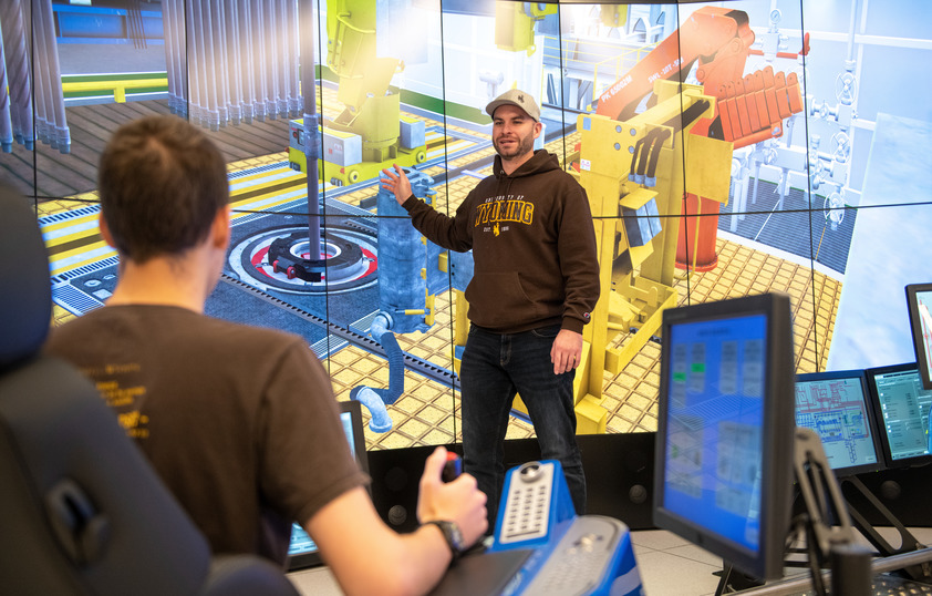 Two students in the drilling simulator