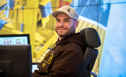 A U.W. student posing in the drilling simulator
