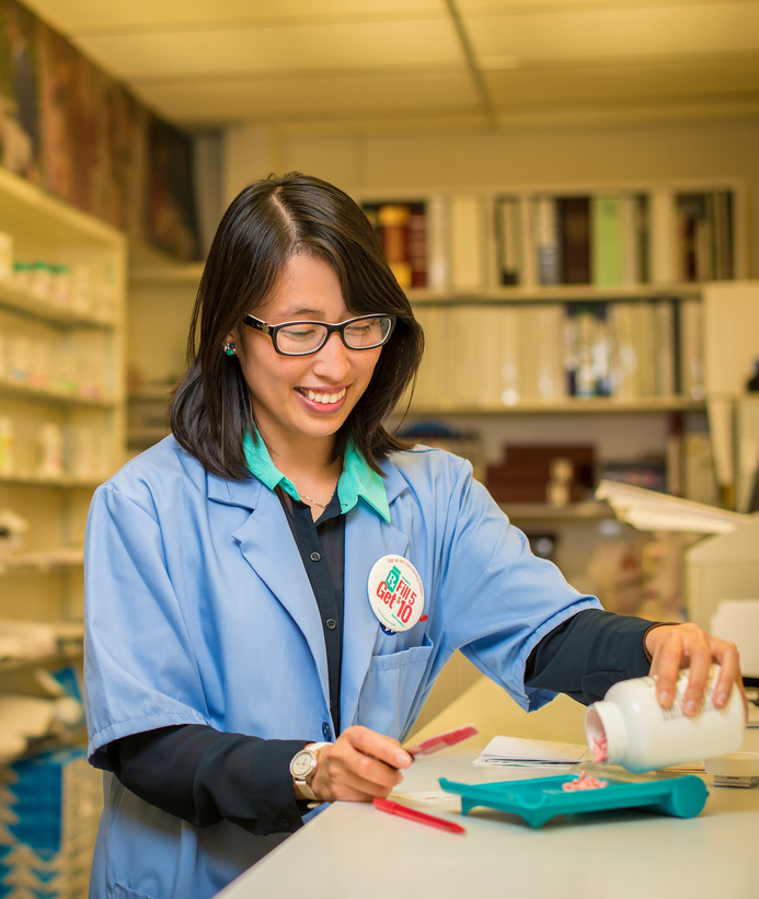 Pharmacist empties a prescription bottle