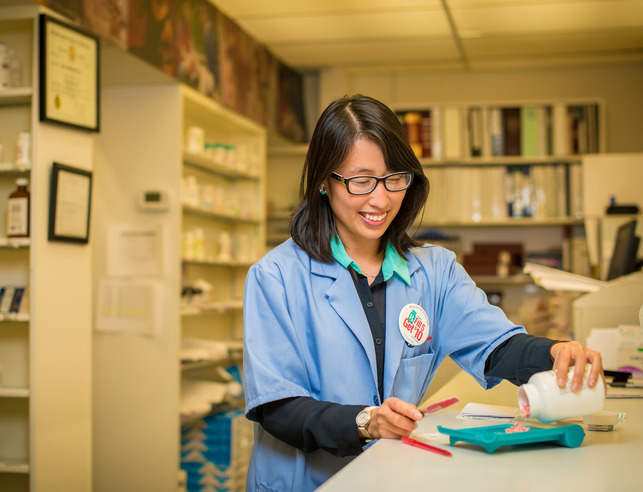 Pharmacist empties a prescription bottle