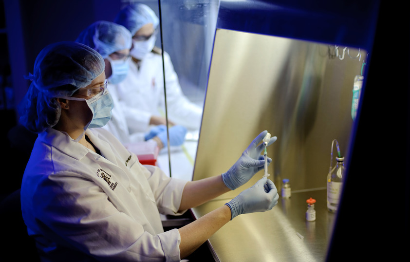 Student in lab filling a syringe