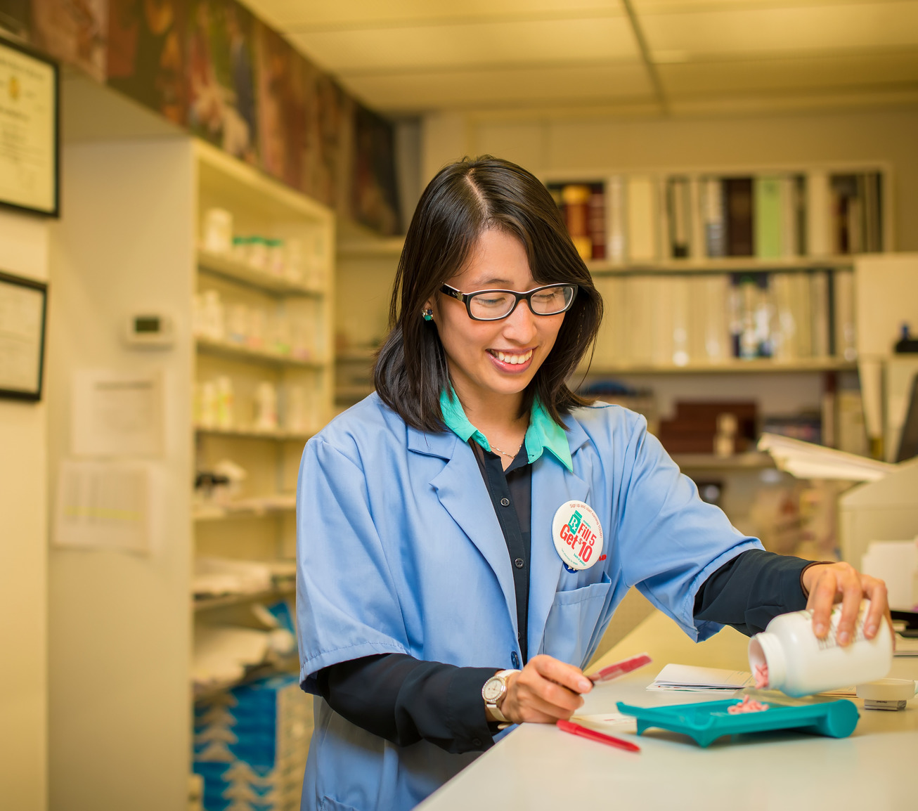 Pharmacist counting pills