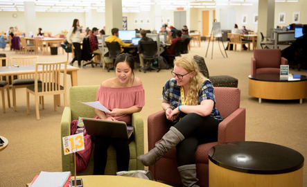 Two students sit next to each other