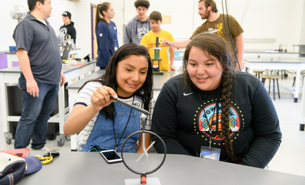 Two students do a physics experiment