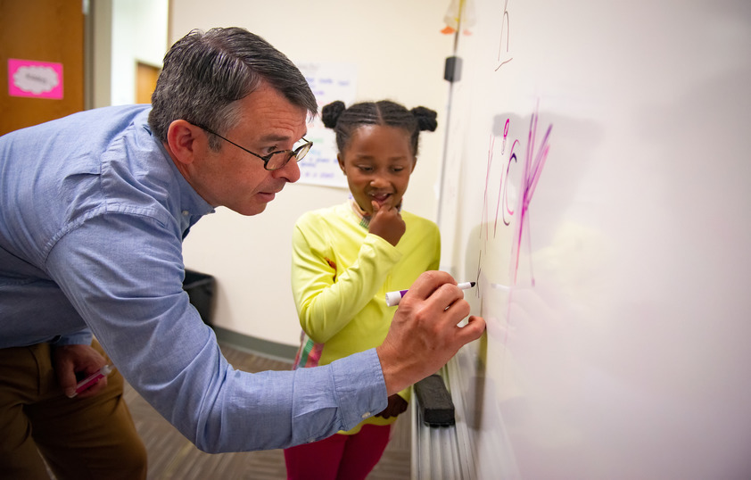 Counselor drawing on white board