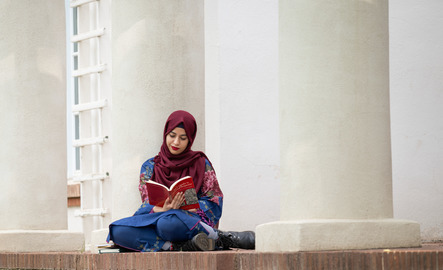 Student sits outside reading