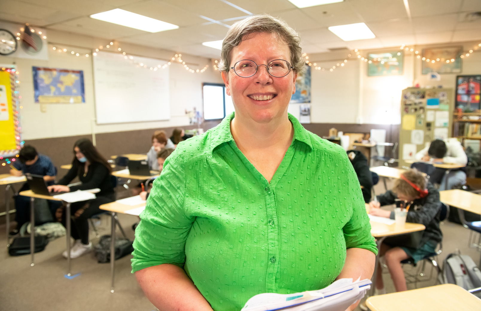 Principal standing in classroom