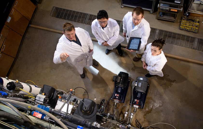 Four people standing in lab