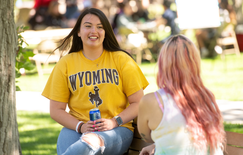 Two students talking to each other on campus