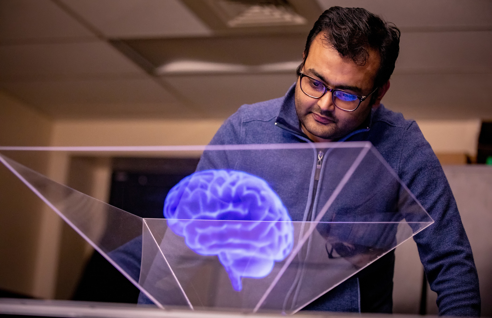 Student looking a brain hologram