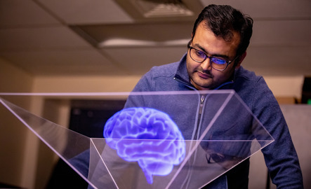 Pschology student looking a brain hologram
