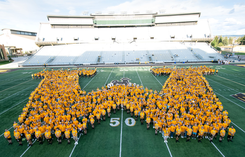 Students forming a "W" on the football field