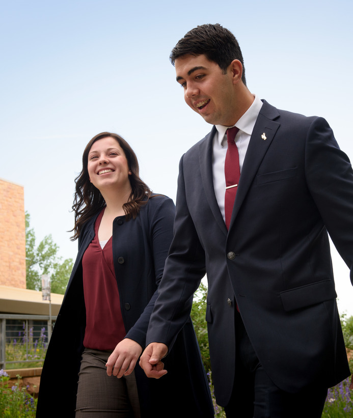 Two students walk in suits